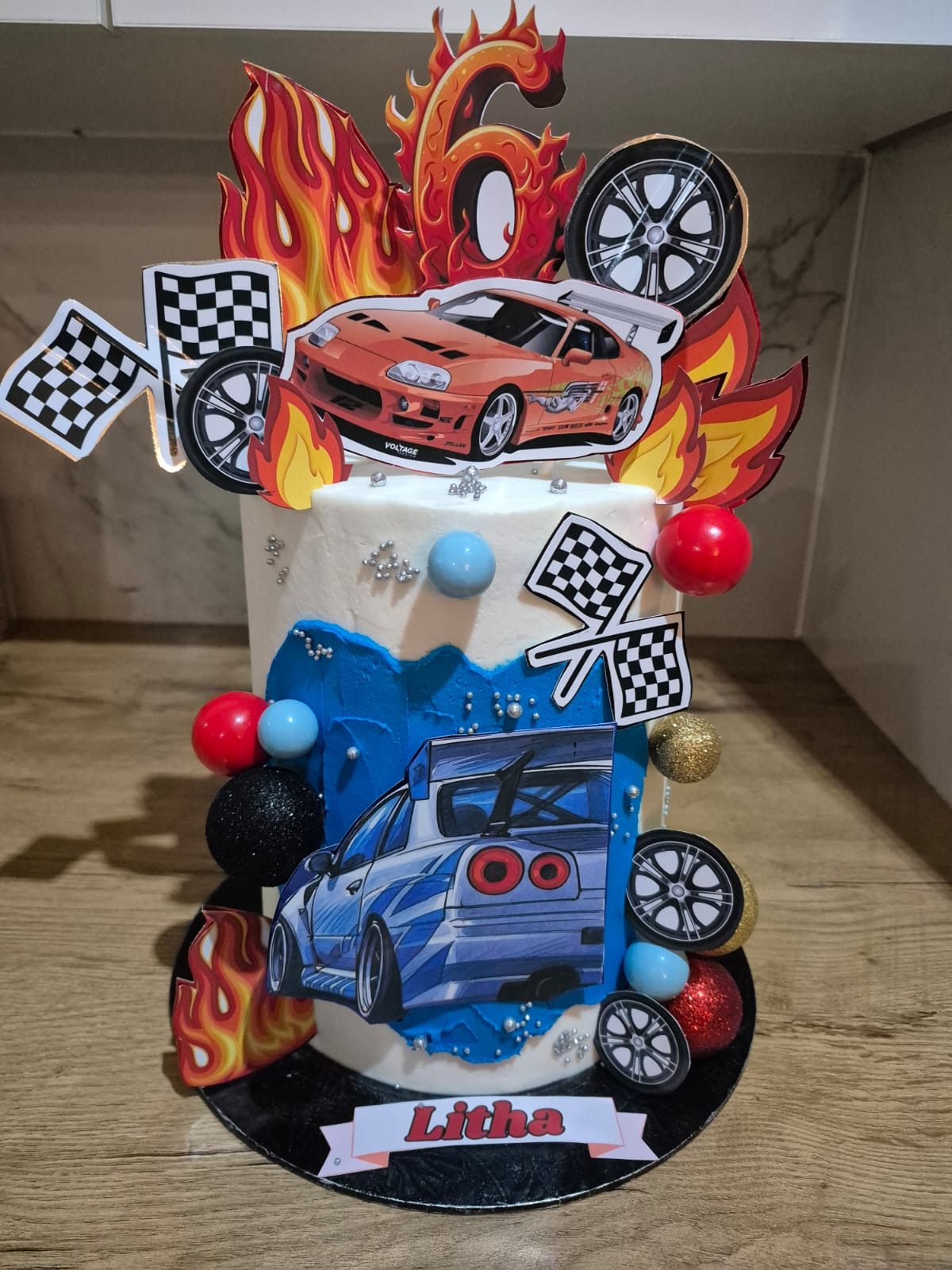 A racing car and flames themed tower birthday cake, a recent Rosy's Cakes and Events creation